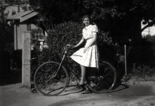Helen Dunshea on bicycle at Acton cottage no 4