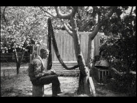 Ernest Dunshea making camouflage net at Acton cottage no. 4