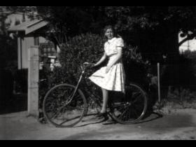 Helen Dunshea on bicycle at Acton cottage no 4